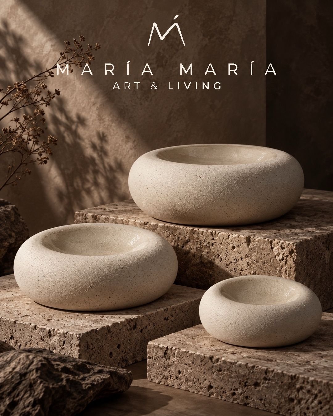 Three ivory vessels on stone plinths with the MARÍA MARÍA logo
